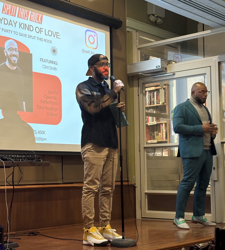 Clint Smith, Everyday Kind of Love's featured poet, stands on stage beside Billy Sanders, the ASL interpreter for the evening.
