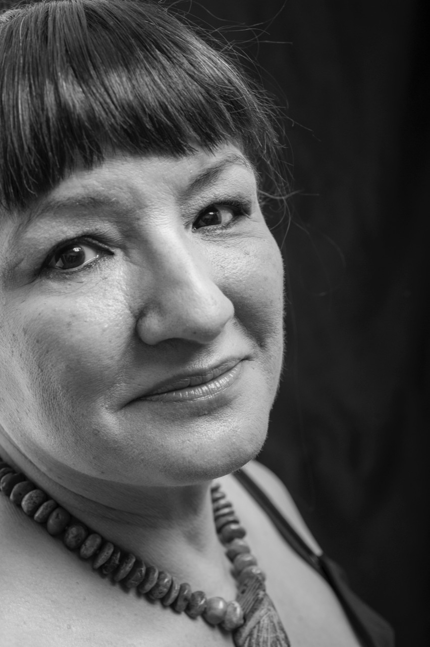Sandra Cisneros appears in black and white and close up and looks at the camera. 