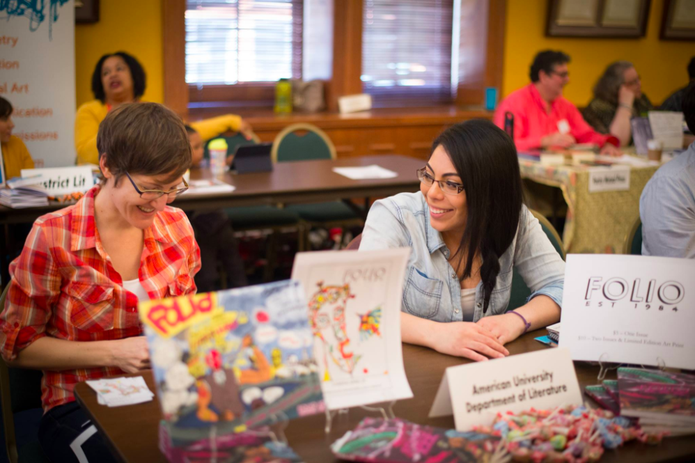 Image of two people sitting at a table at the 2016 Social Change Book Fair